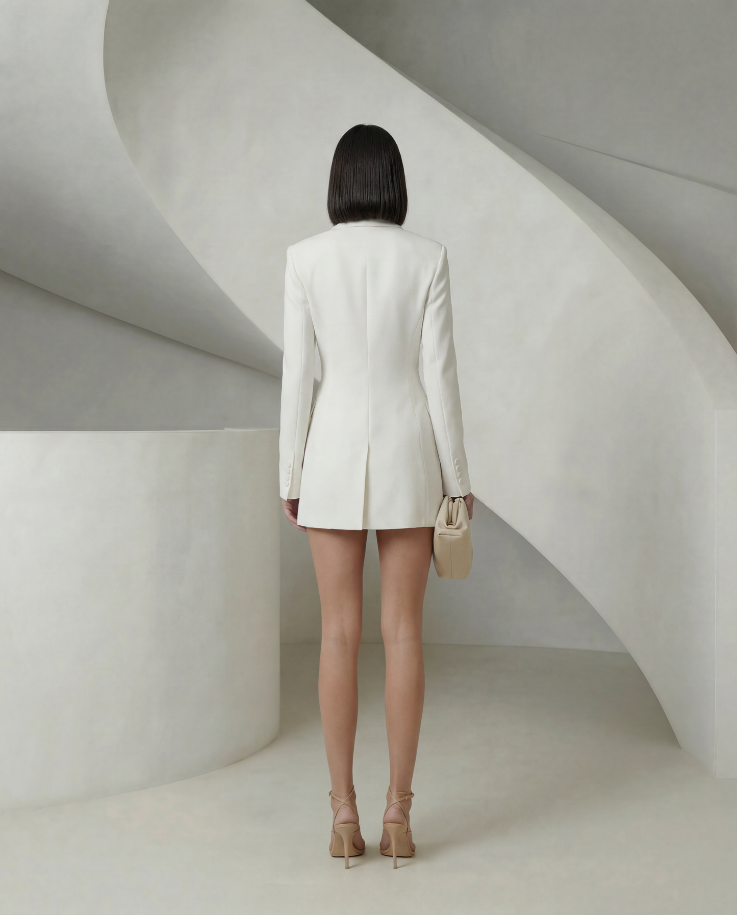White double-breasted blazer dress from behind showing the centre back vent, full length