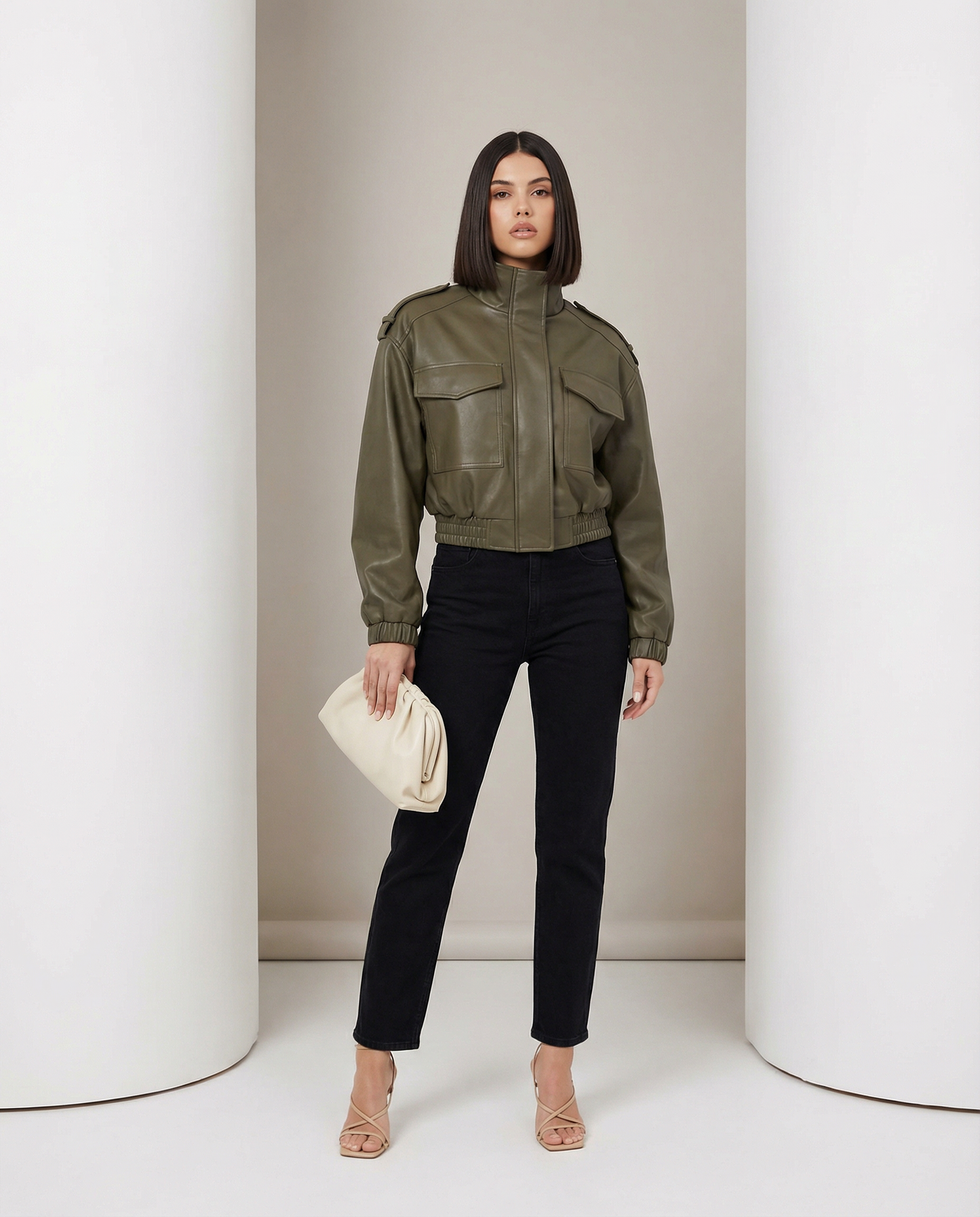 Olive leather bomber with boxy shoulders and chest flap pockets, worn with black straight jeans