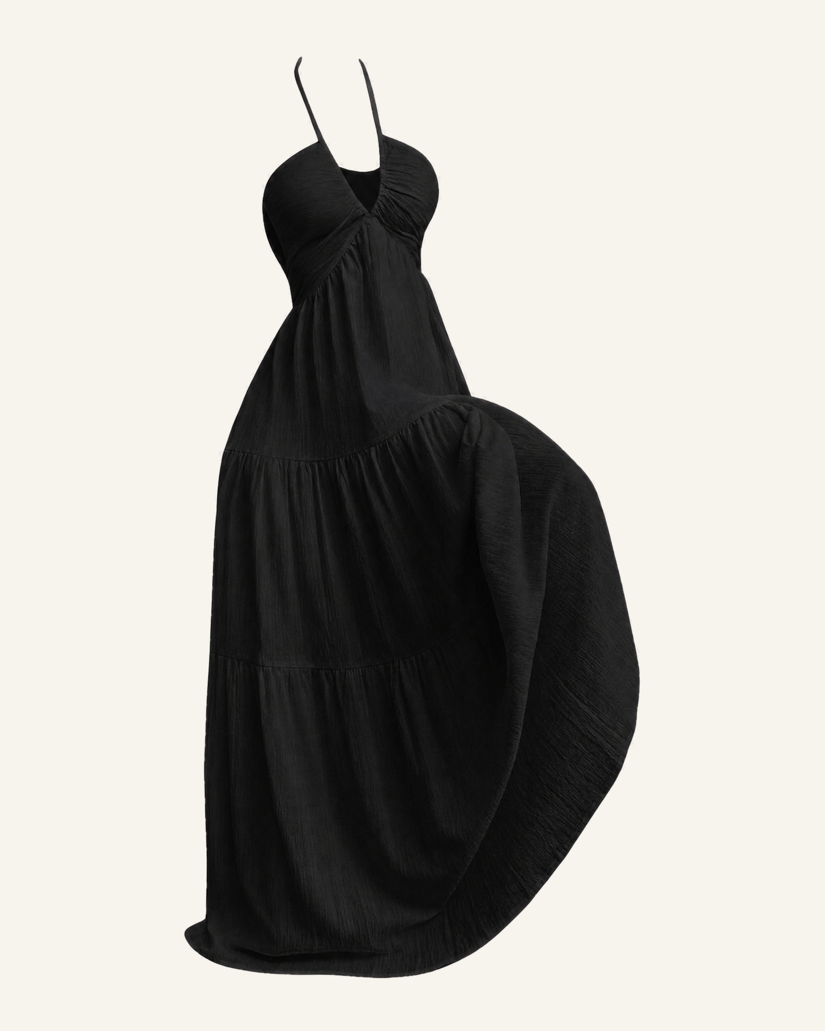 The Alva halter tiered maxi dress in black, shown alone against a bone background, full length