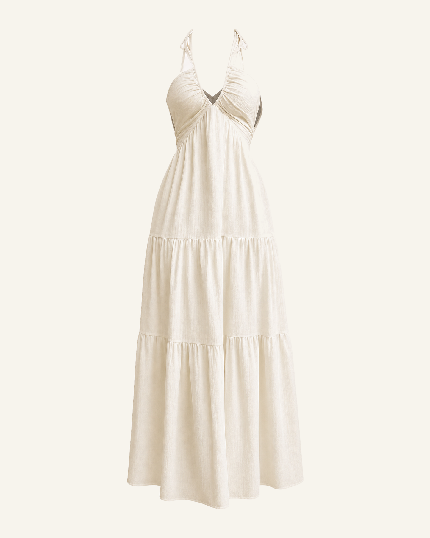 The Alva halter tiered maxi dress in cream shown alone against a bone background, full length