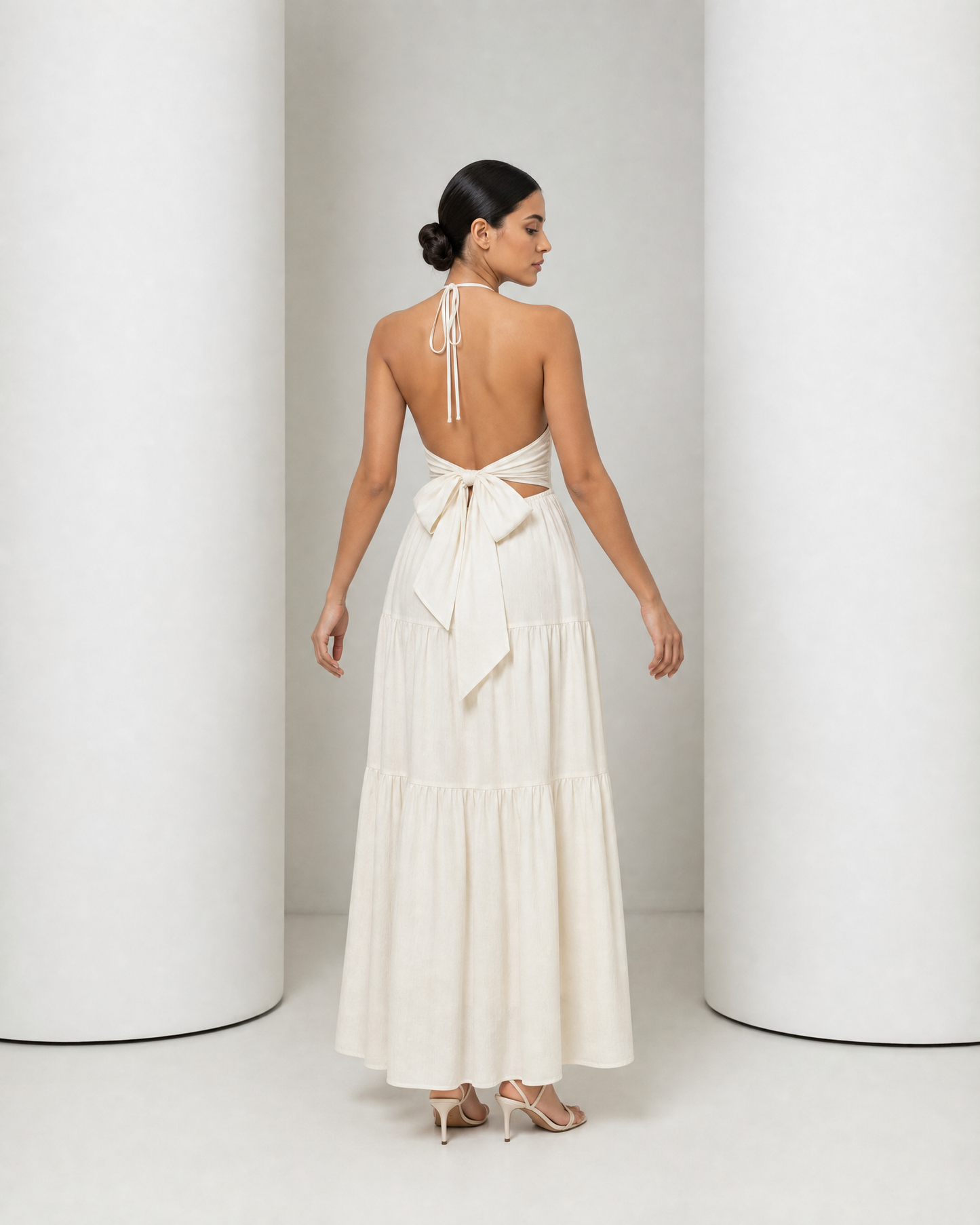 Back of the cream Alva dress, open back with the sash tied in a bow at the waist