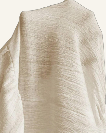 Macro of the Alva crinkle weave, fine texture across the light fabric