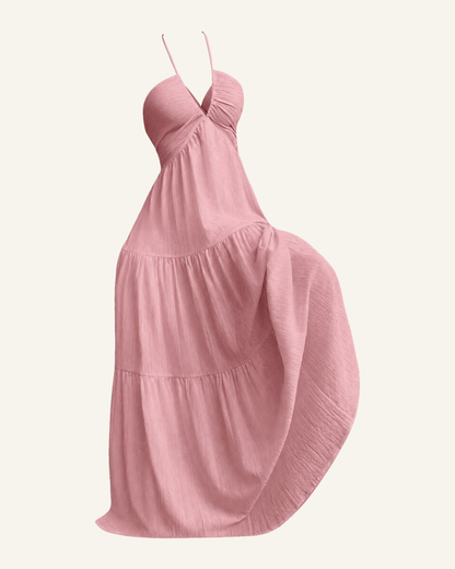The Alva halter tiered maxi dress in soft rose pink, shown alone against a bone background, full length