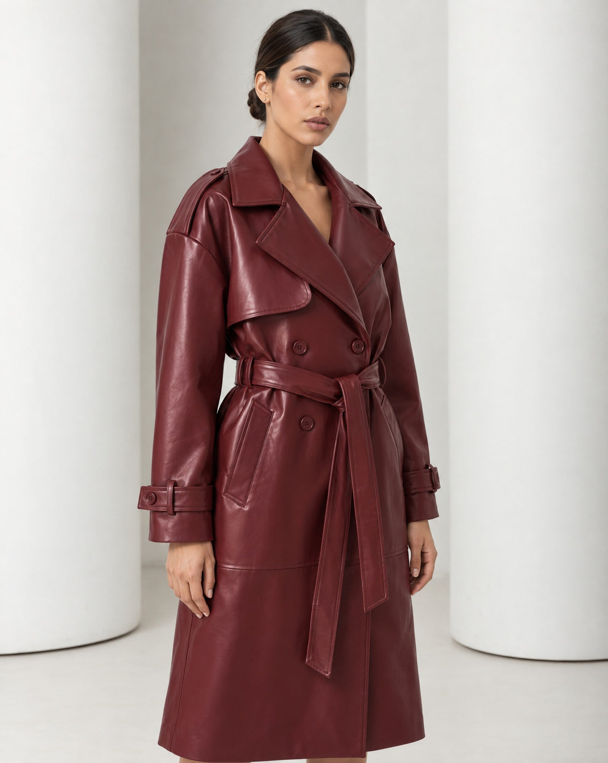 Close view of the Alya burgundy trench, wide notched lapels, storm flap and double-breasted buttons
