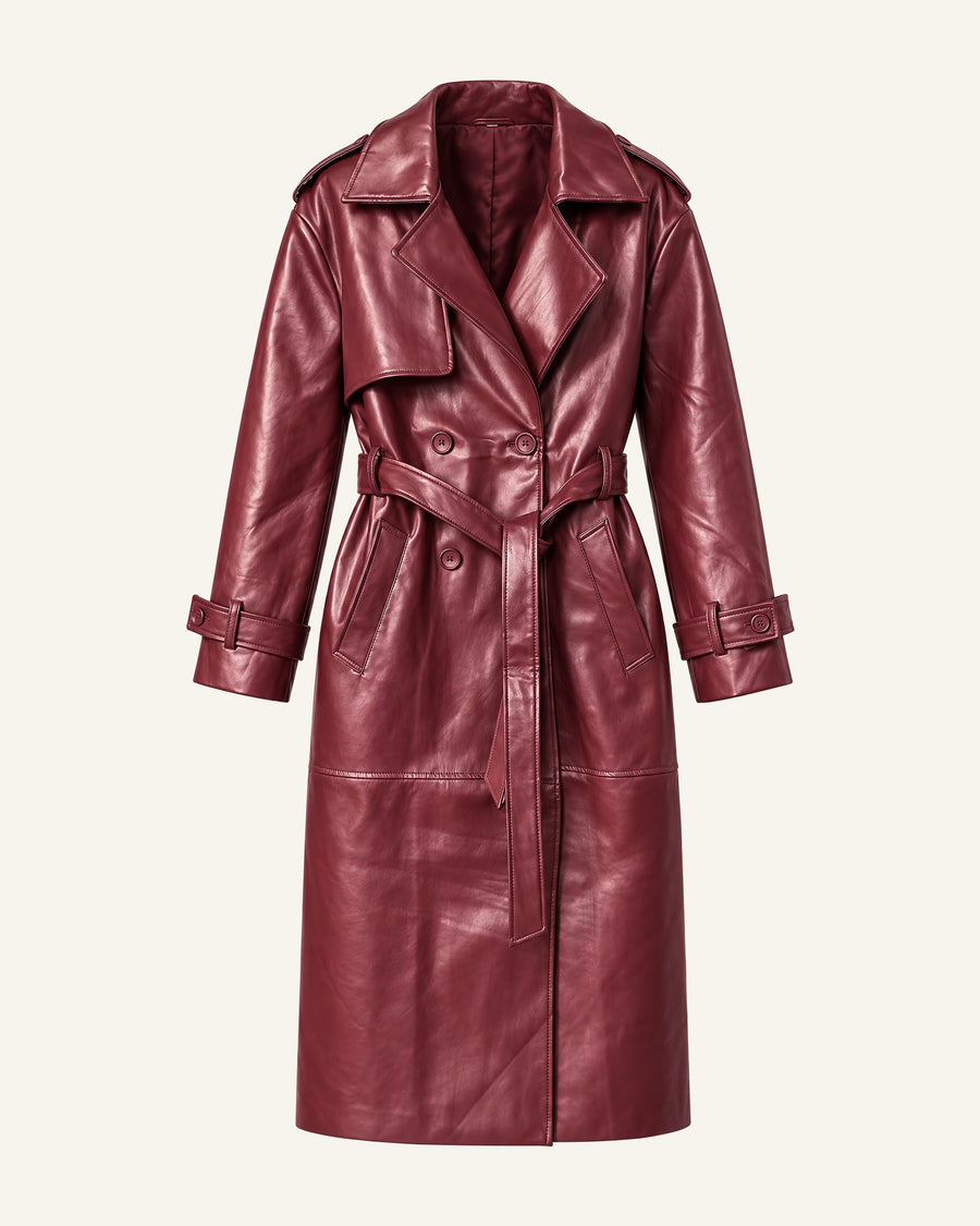 Model in the Alya vegan leather trench in burgundy, belted at the waist and falling to mid-calf