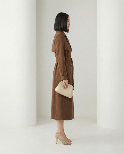 Alya suede trench shown from the side, storm flap and buckled cuff straps, hem at mid-calf