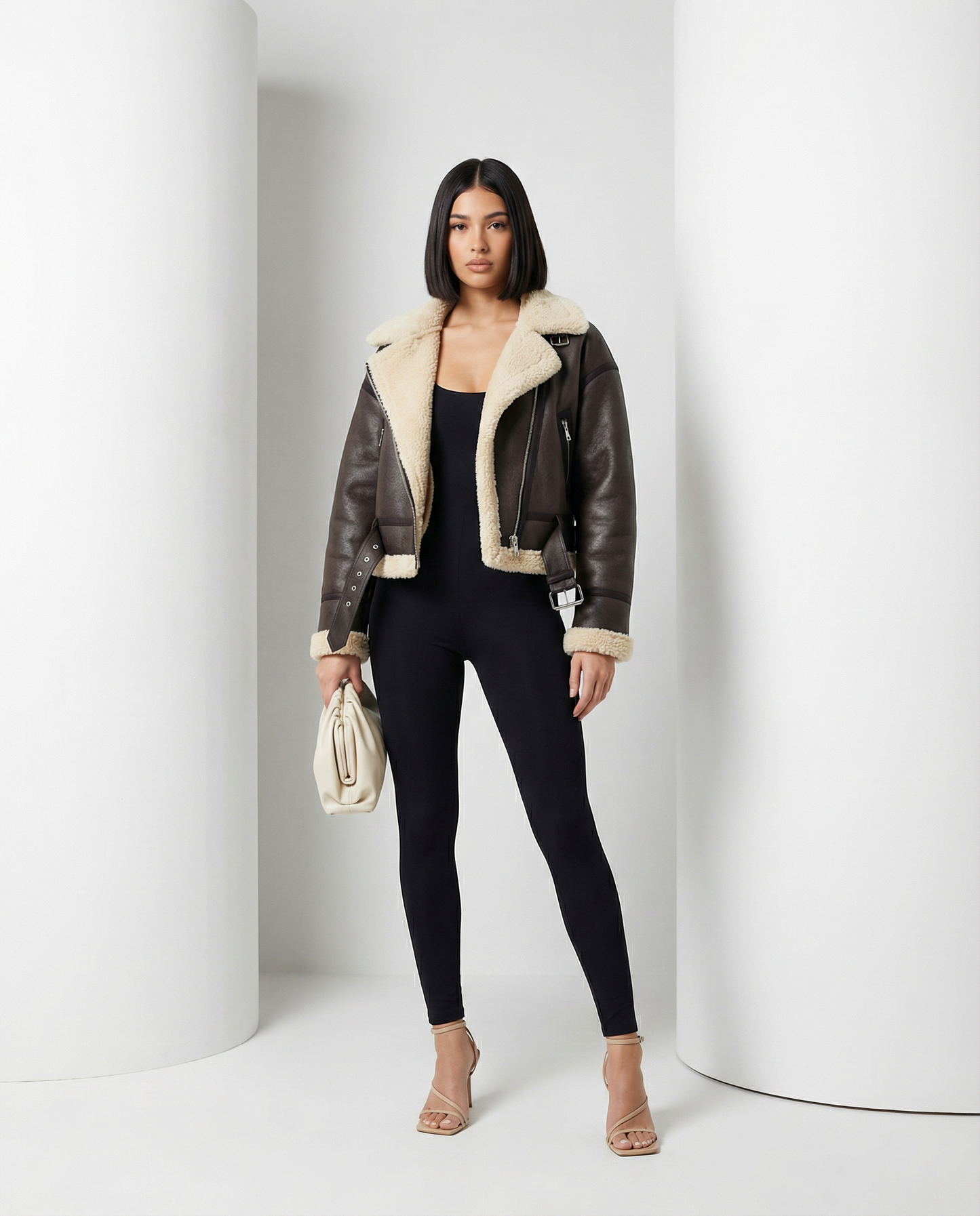 Dark brown Ares aviator jacket with a cream shearling collar worn open over black leggings