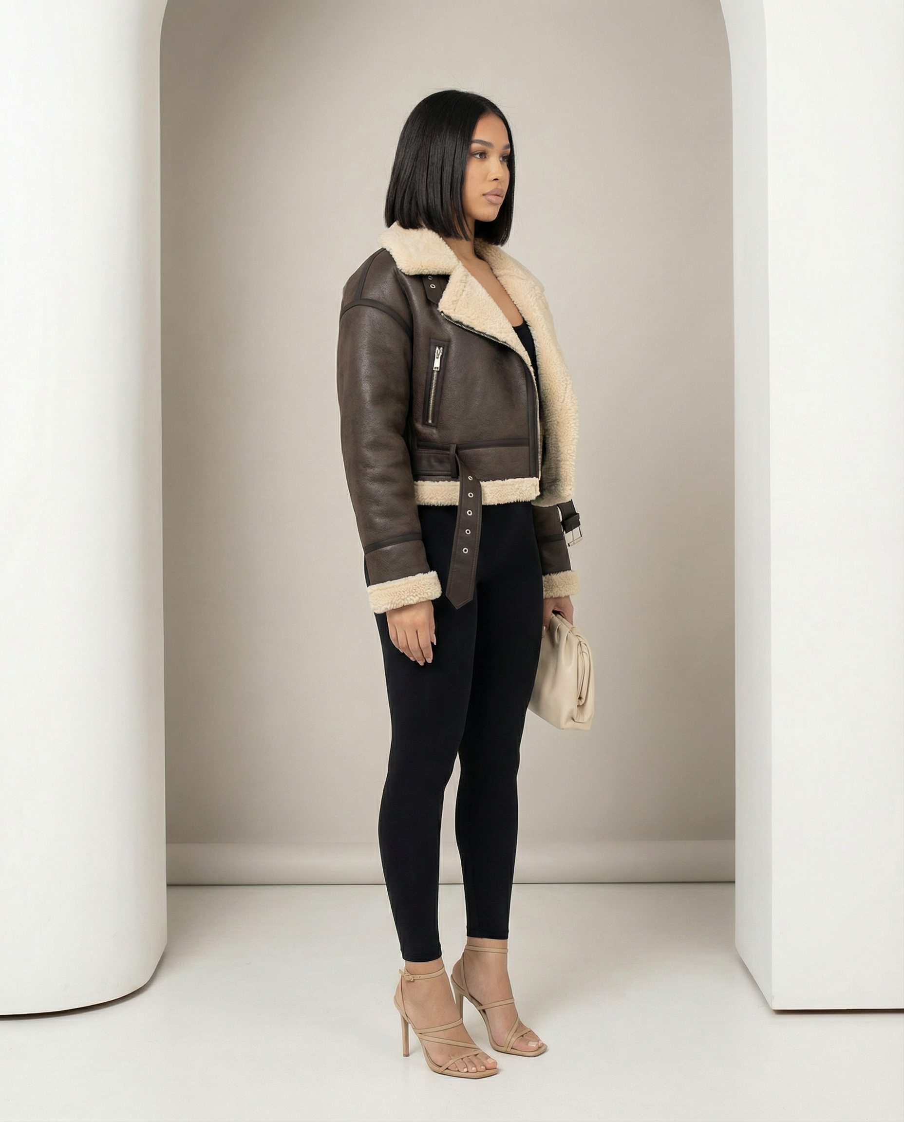 Ares shearling-lined jacket in brown shown from the side, belt tab hanging loose at the hip