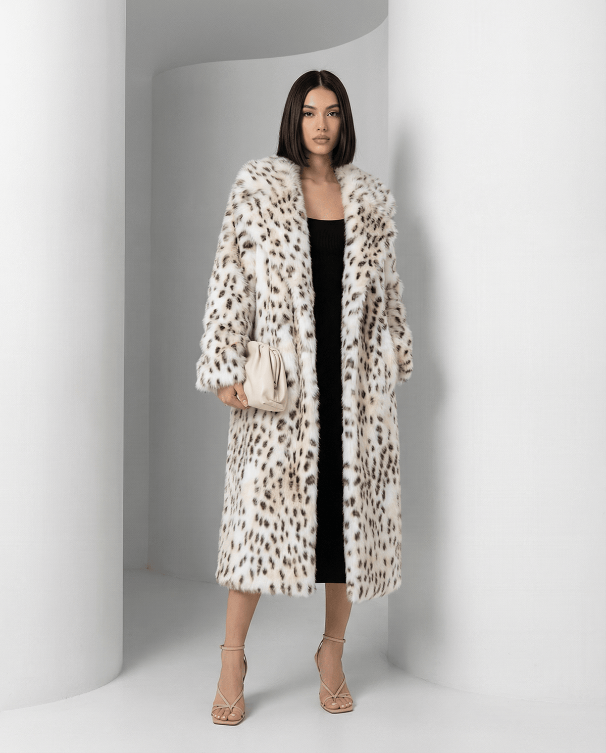 Asteria snow-leopard faux-fur coat worn open over a black midi dress, front view, full length