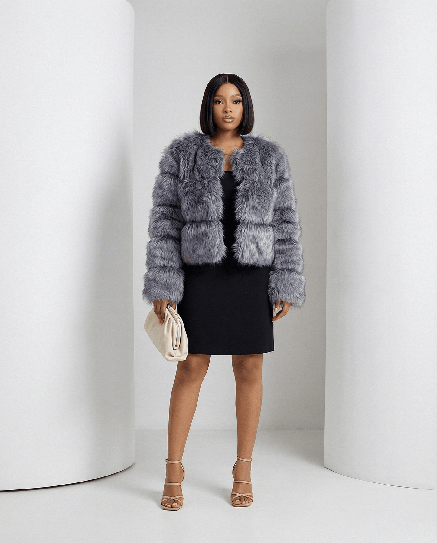 Glacier grey Astra faux-fur jacket worn open over a black mini dress, full length