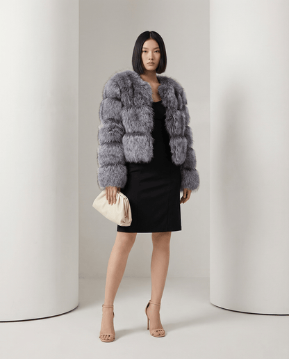 Glacier grey Astra faux-fur jacket with banded pile panels, worn front on over a black dress