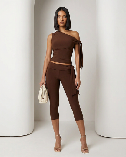 Bitter chocolate Aura asymmetric set with one-shoulder tie top and capri leggings, full length