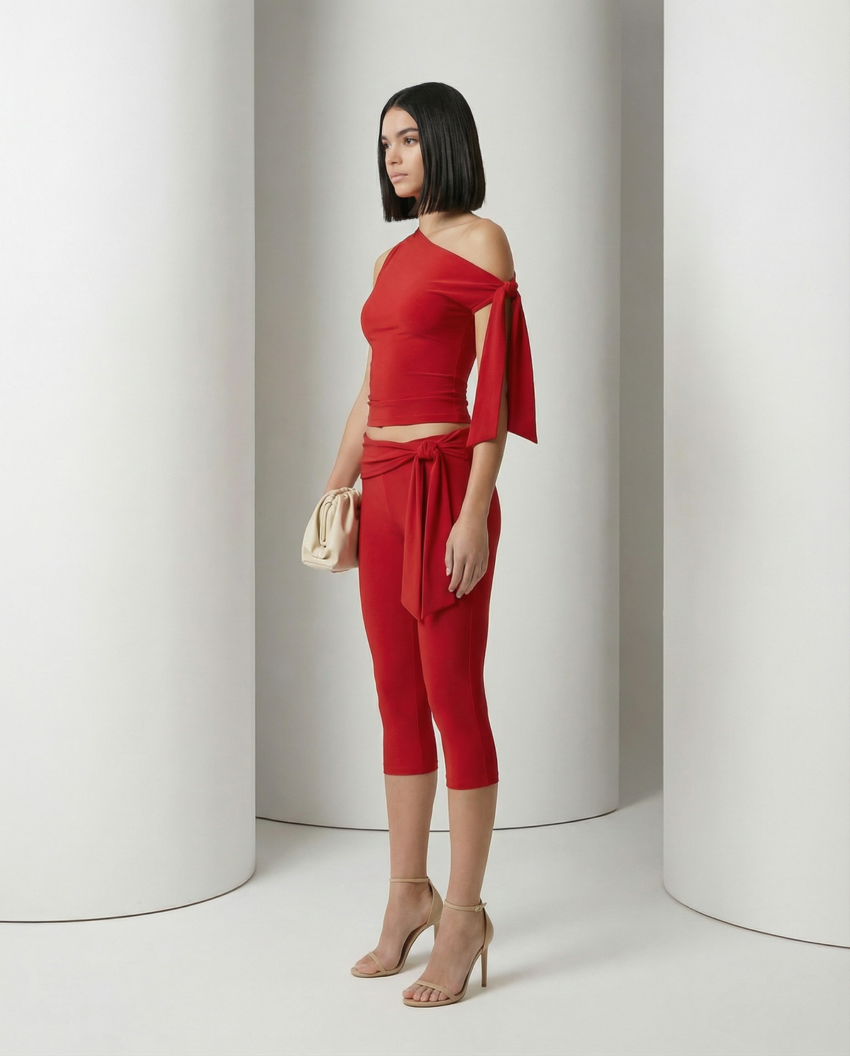 Aura asymmetric set in scarlet red viewed from the side, long shoulder tie draped past the waist