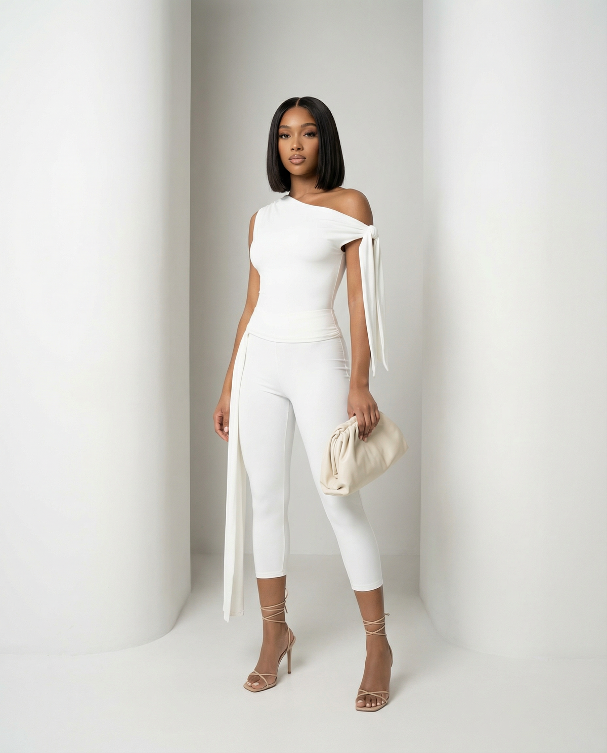 Aura asymmetric set in white, draped shoulder tie falling long at the side, standing front view