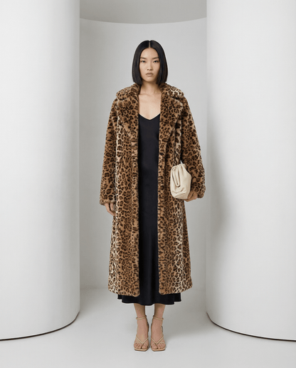 Cocoa leopard Aurelia coat open over a black slip dress with a cream clutch, full length