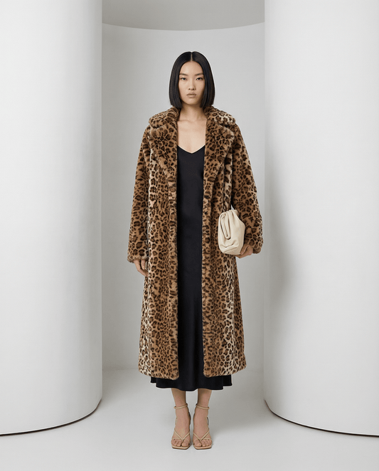 Cocoa leopard Aurelia coat open over a black slip dress with a cream clutch, full length