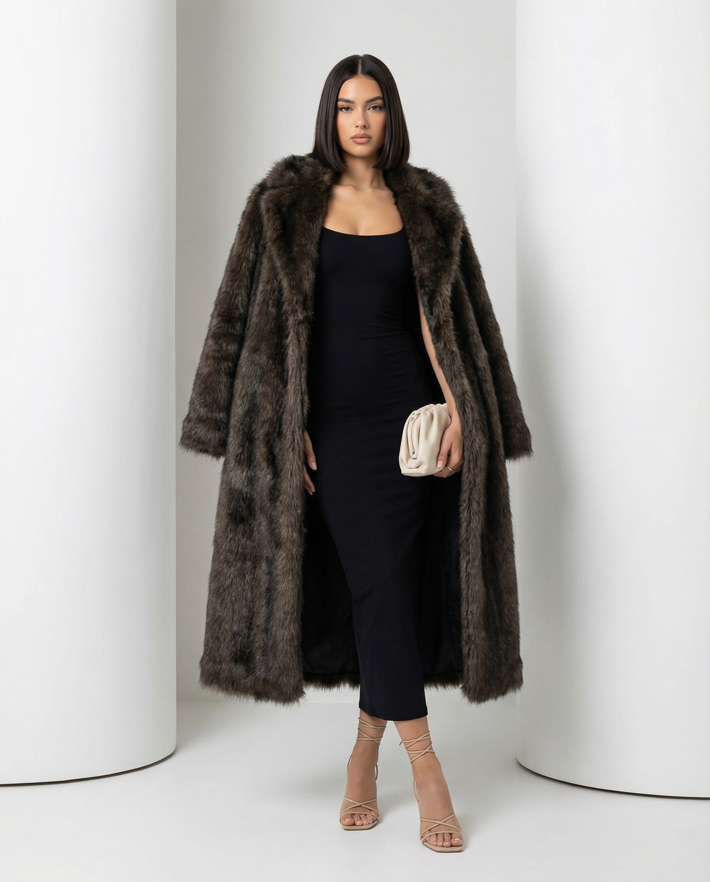 Brown longline faux-fur coat open over a fitted black midi dress, front view, full length