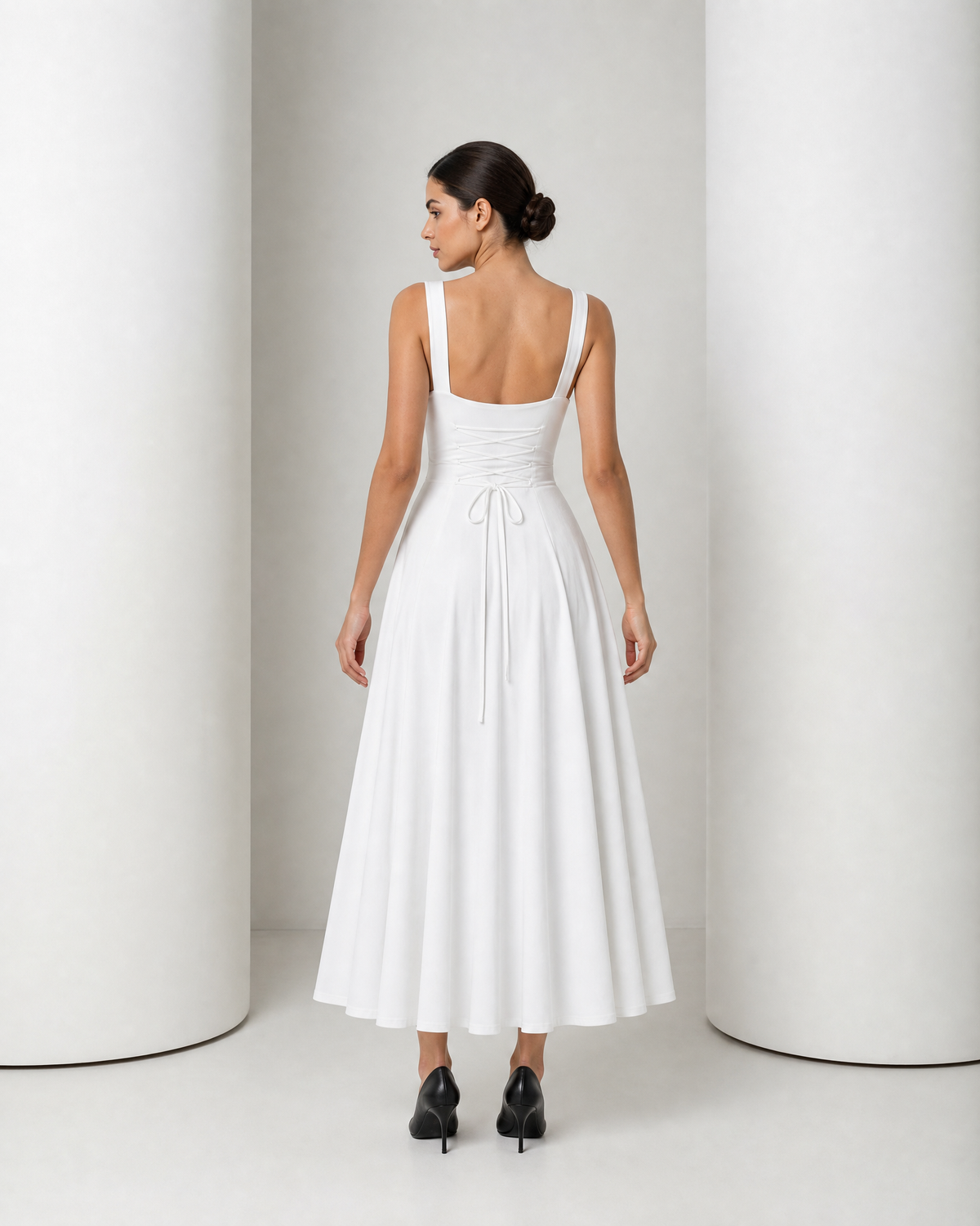 Back of the white Elin dress, low square back with the corset cord crossing the waistband