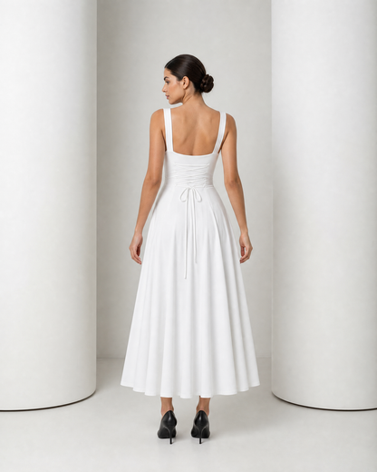 Back of the white Elin dress, low square back with the corset cord crossing the waistband