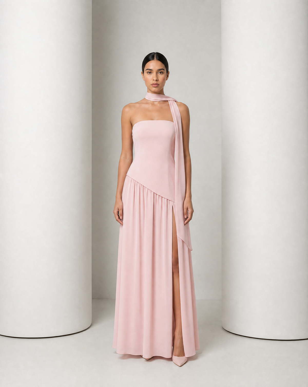 Model in the Embla lace-back chiffon maxi in blush, strapless bodice and the high side slit open