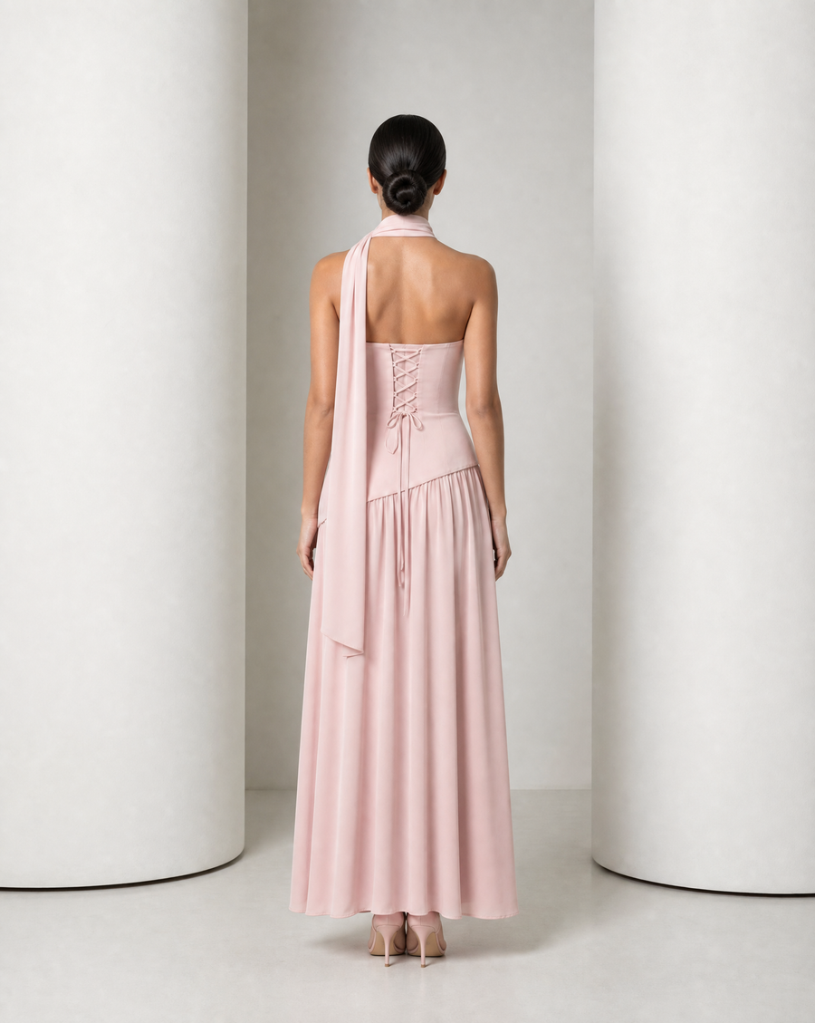 Model in the Embla lace-back chiffon maxi in blush, strapless bodice and the high side slit open