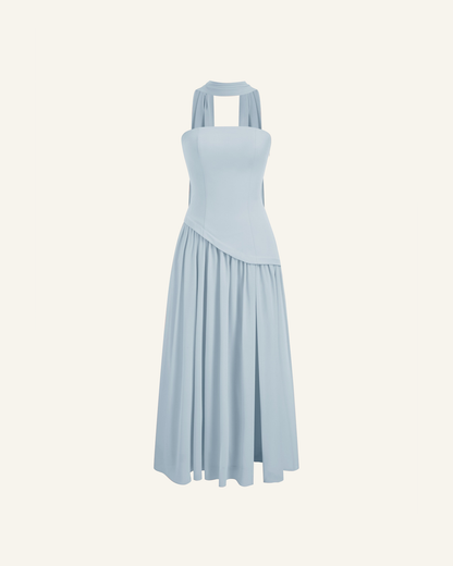 The Embla lace-back maxi in powder blue, strapless bodice and full chiffon skirt, alone on a bone background