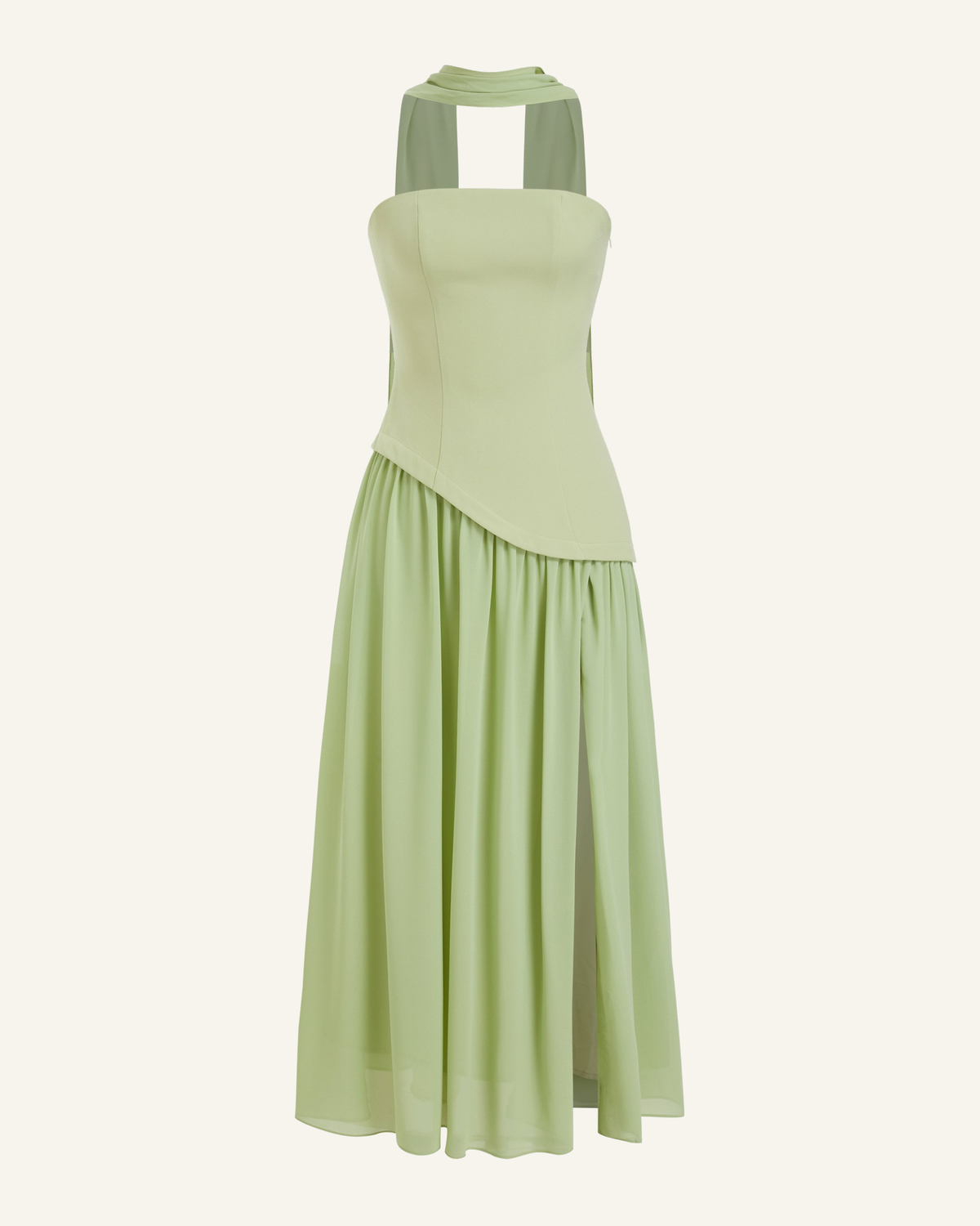 The Embla lace-back maxi in sage green, strapless bodice and full chiffon skirt, alone on a bone background