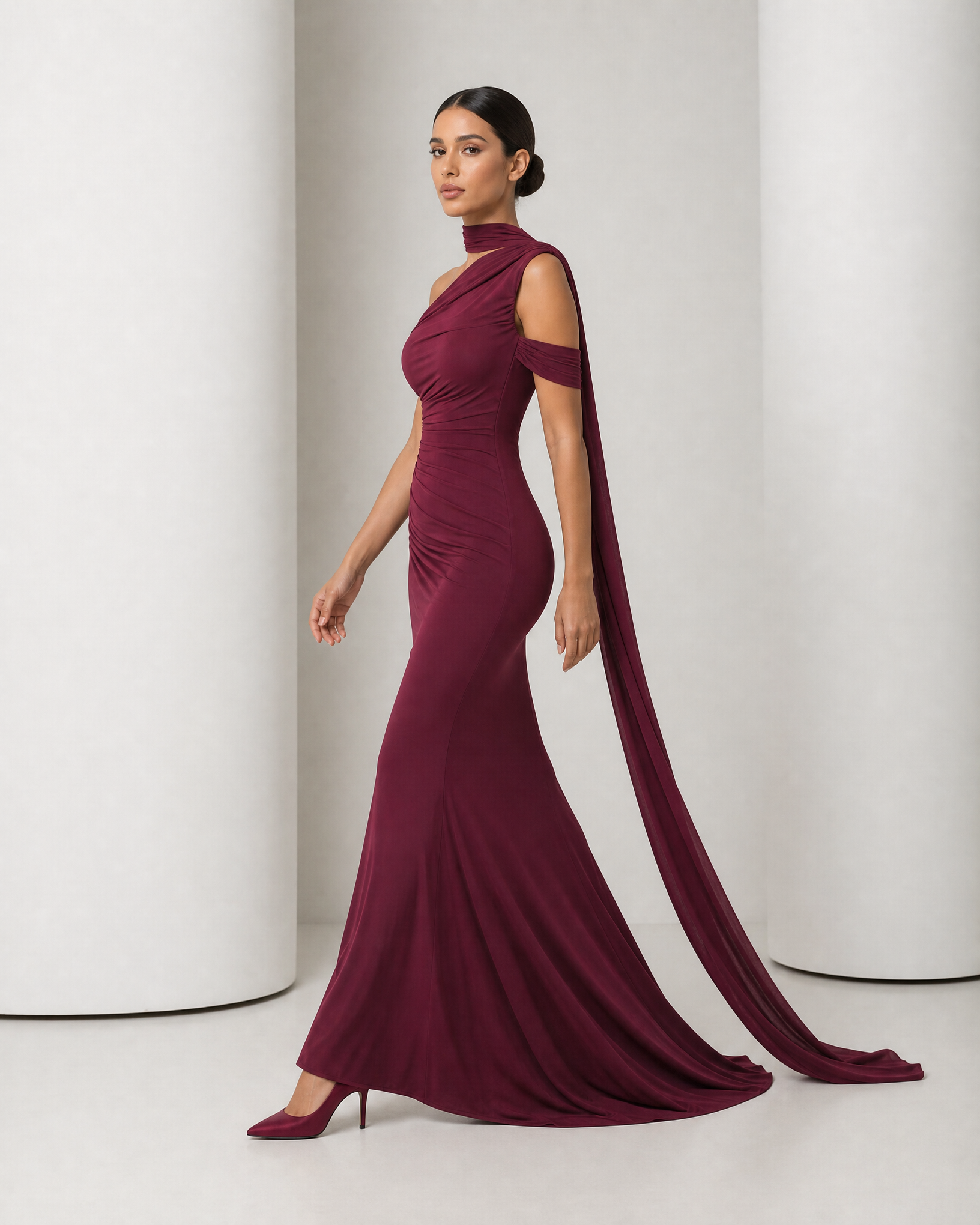 Side view of the wine Freya gown in movement, mermaid hem sweeping and the sash trailing