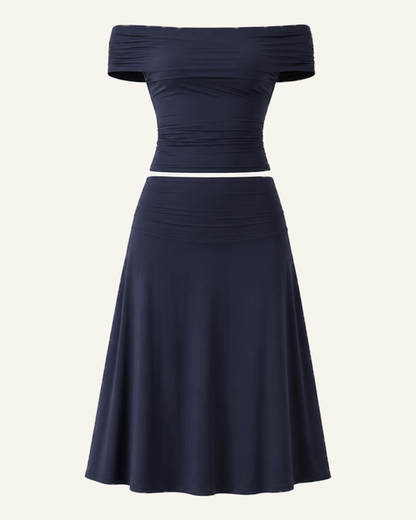 The navy Hedda top and midi skirt set shown alone against a bone background, full length