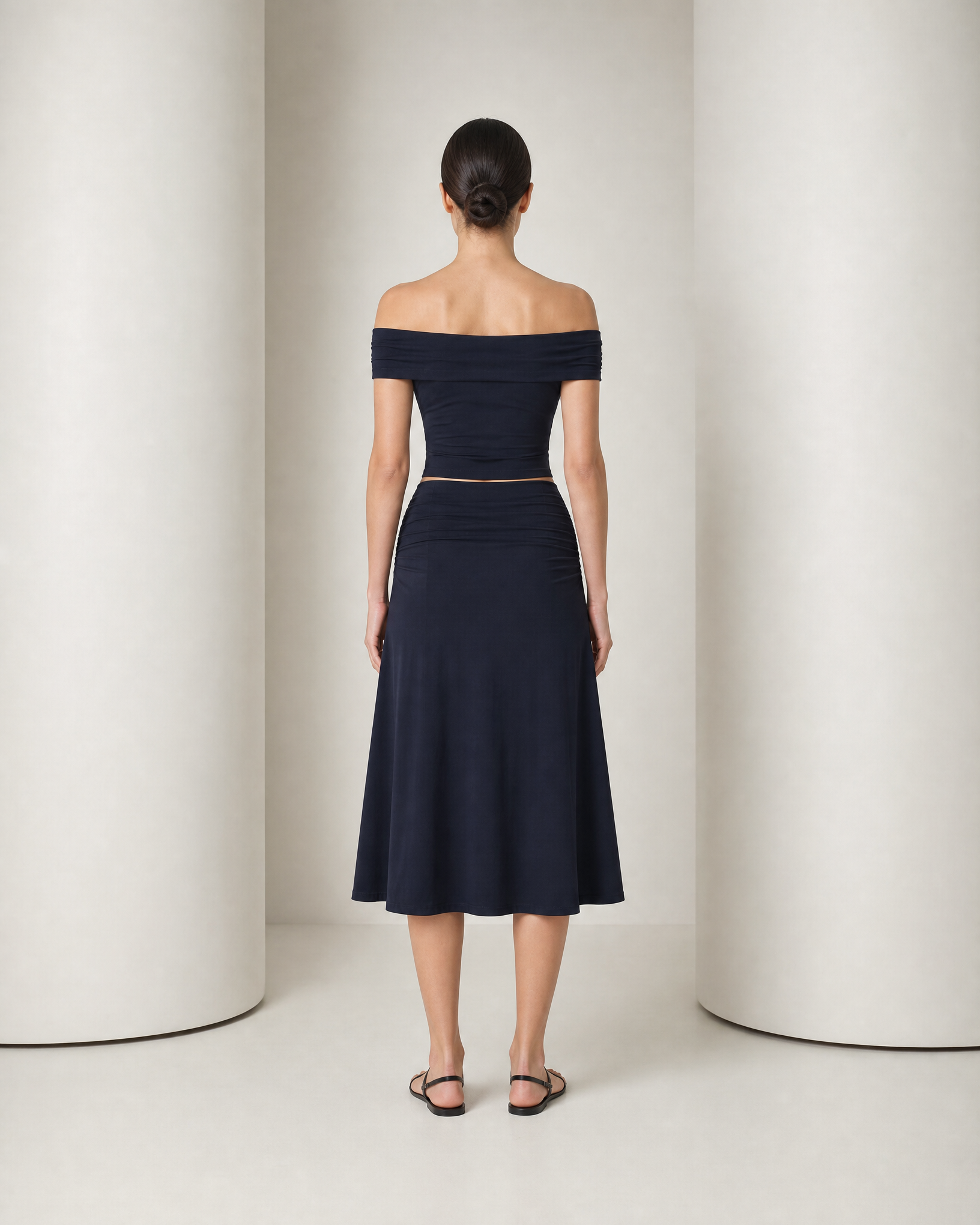 Back of the navy Hedda set, smooth band across the shoulders and a gathered skirt waist