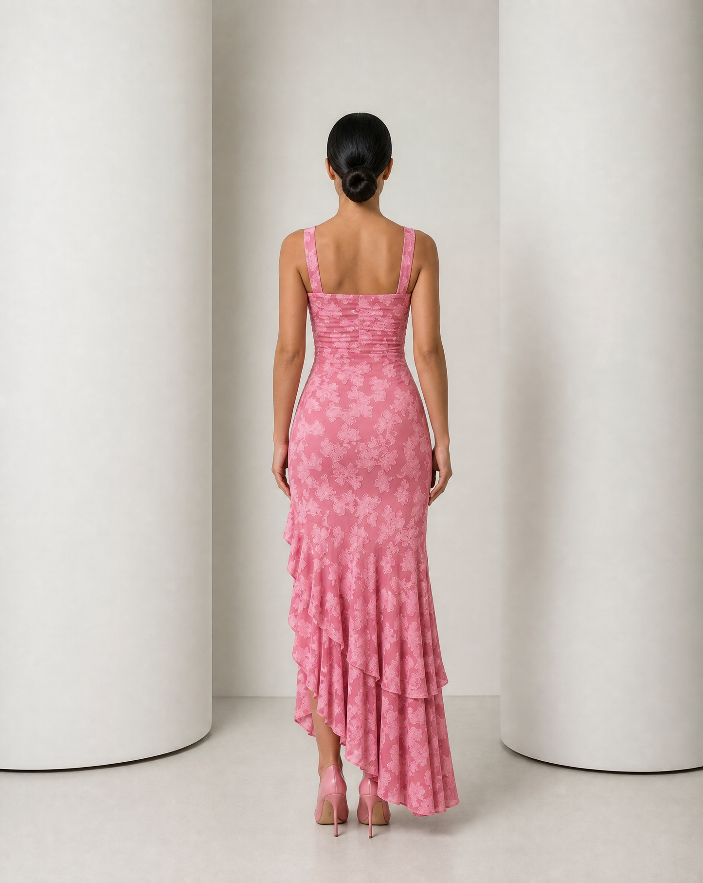Back of the Ilva rose maxi, plain ruched panel and the tiered ruffle cascade falling away behind