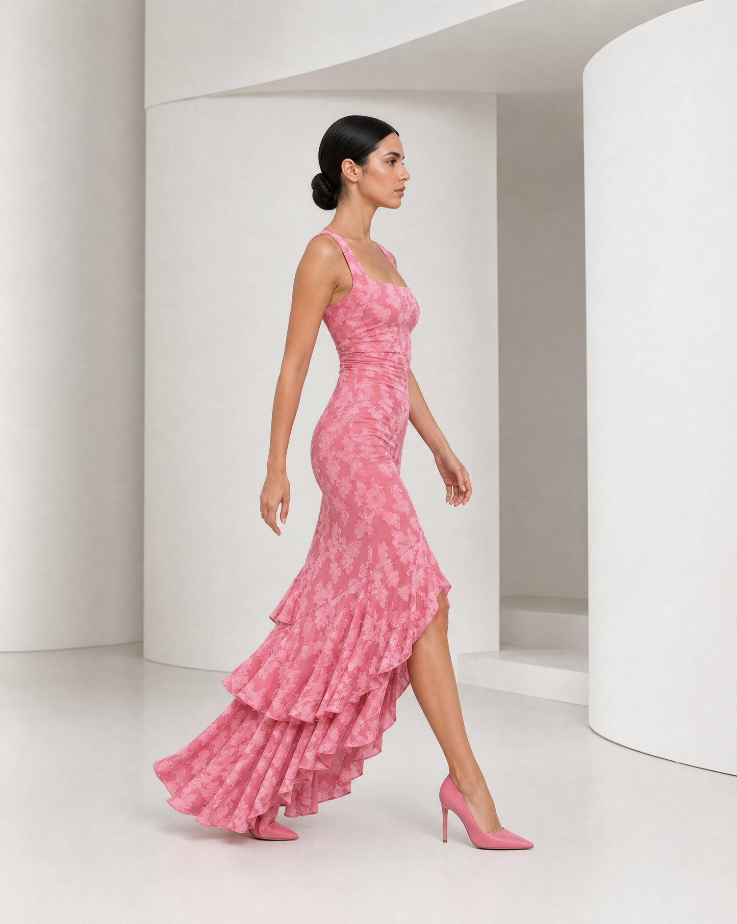 Side view of the Ilva rose maxi in movement, the ruffle cascade lifting and the front slit open