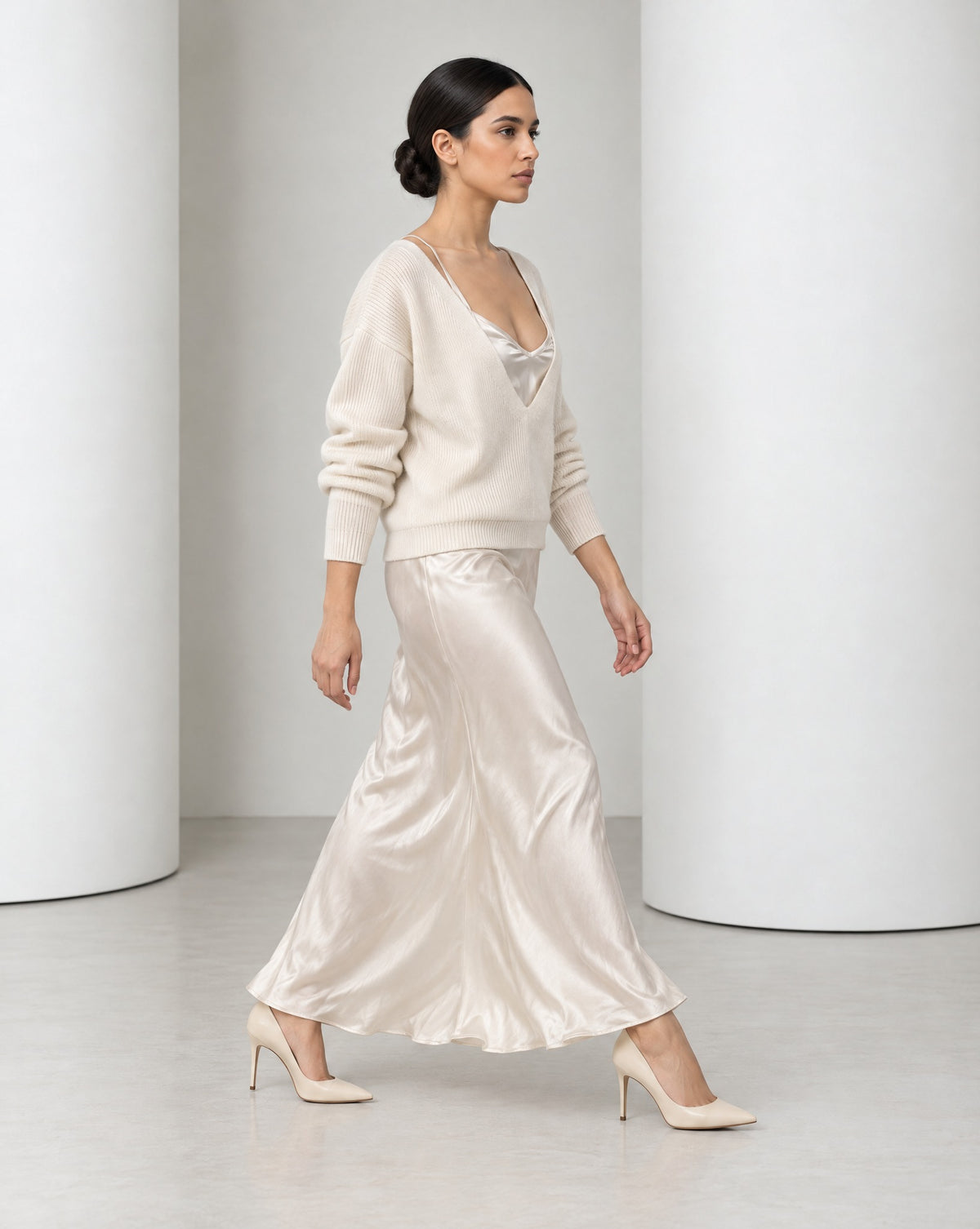 Side view of the Ingrid set in cream mid-stride, bias-cut satin moving at the ankle
