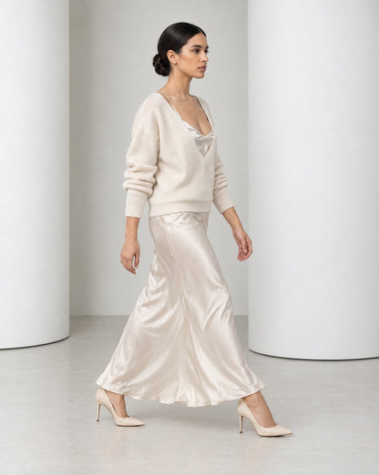 Side view of the Ingrid set in cream mid-stride, bias-cut satin moving at the ankle
