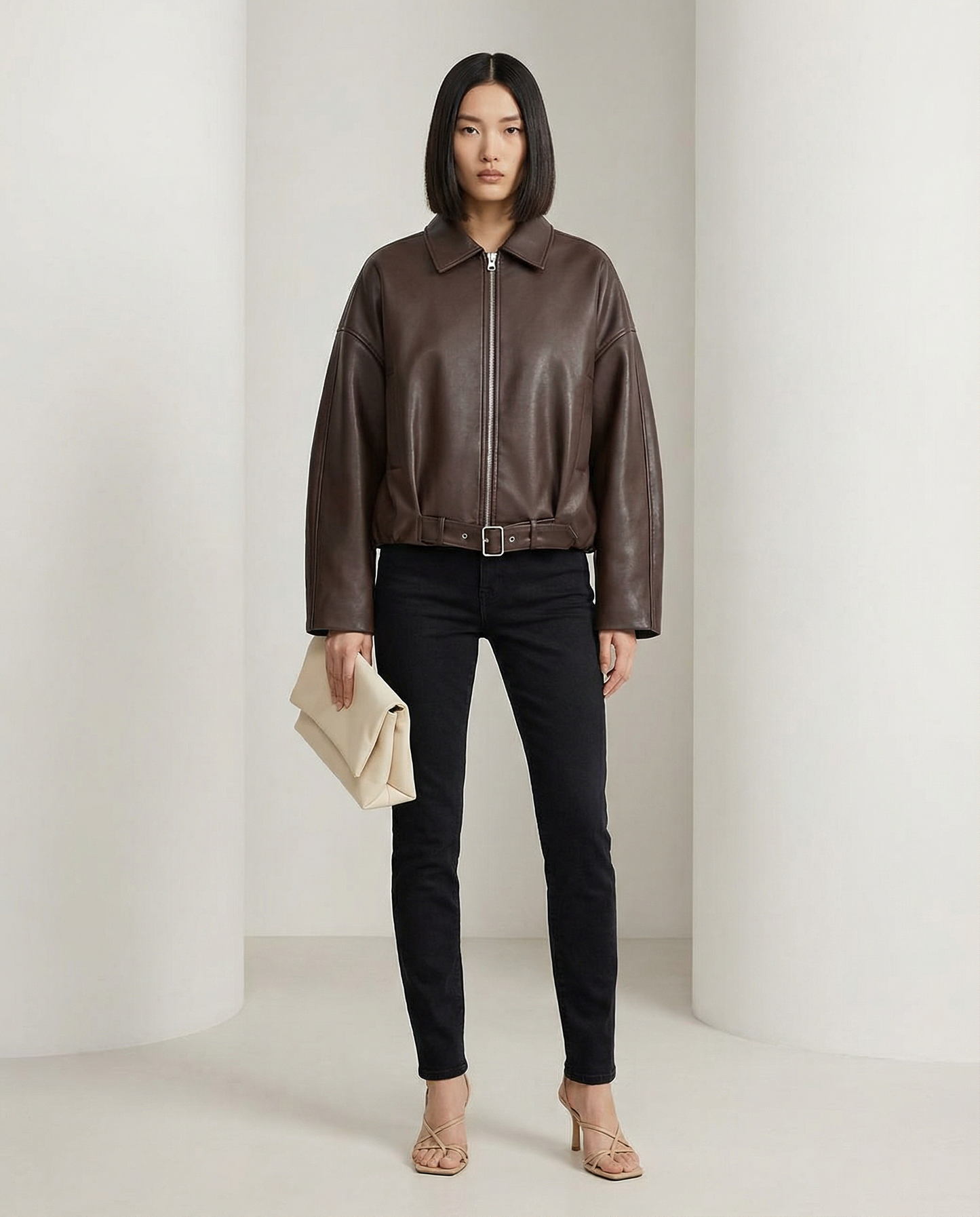 Bitter chocolate cropped jacket buckled at the waist, front view with collar and zip detail