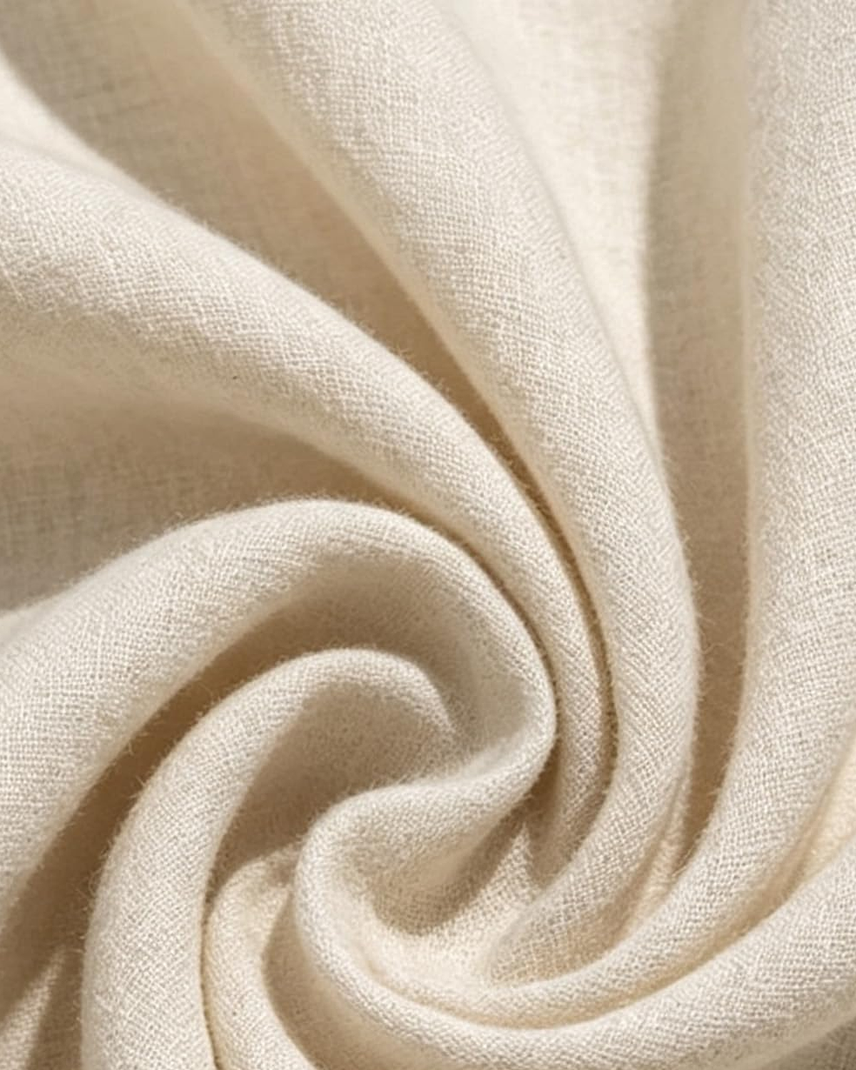 Macro of the Linnea oatmeal fabric, showing the slubbed matte weave and the way it folds