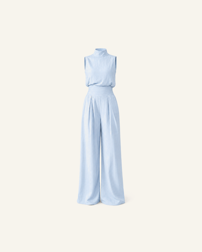 The Linnea pleated wide-leg set in powder blue, mock-neck top and pleated wide-leg trousers, alone on a bone background