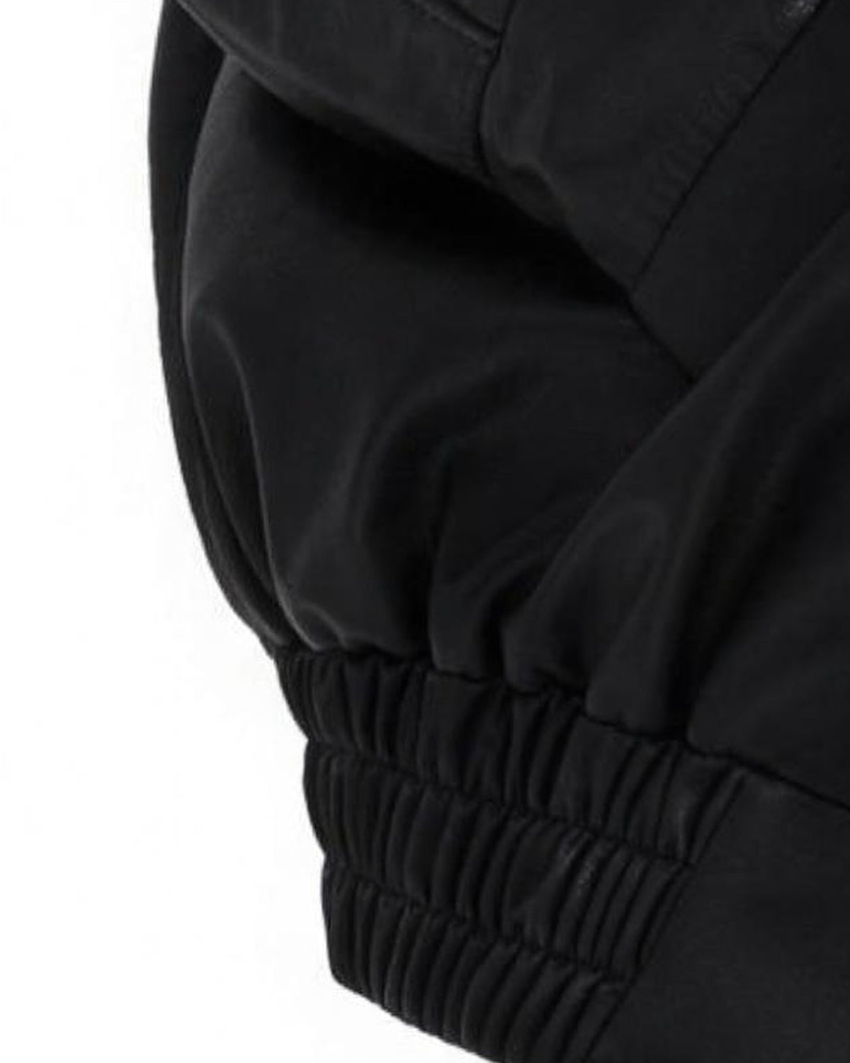 Detail of the gathered elastic hem on the Liv black faux leather jacket