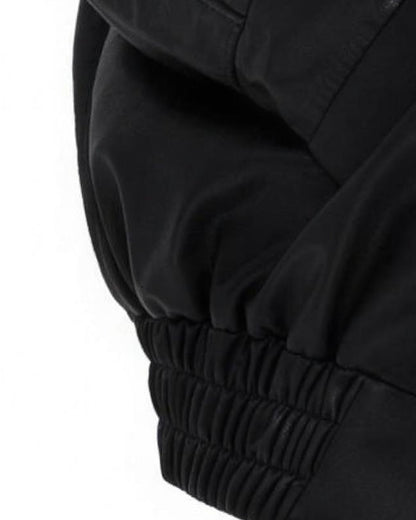 Detail of the gathered elastic hem on the Liv black faux leather jacket