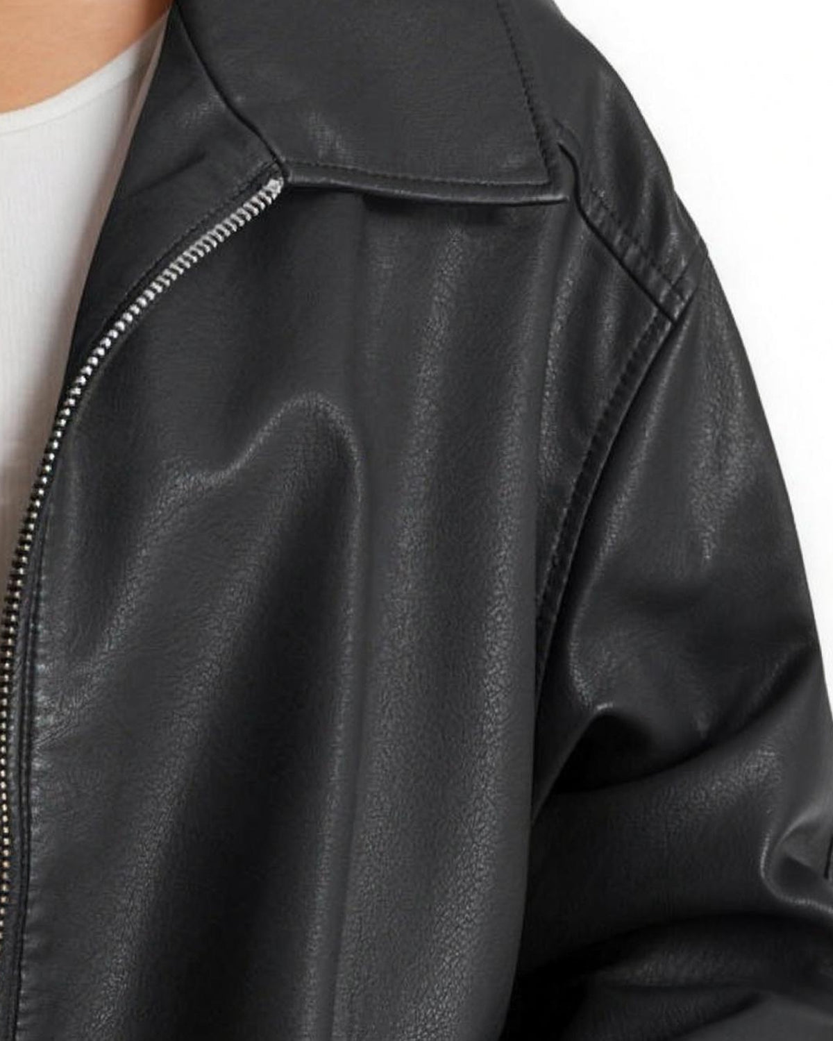 Detail of the point collar, silver zip and dropped shoulder seam on the Liv black jacket