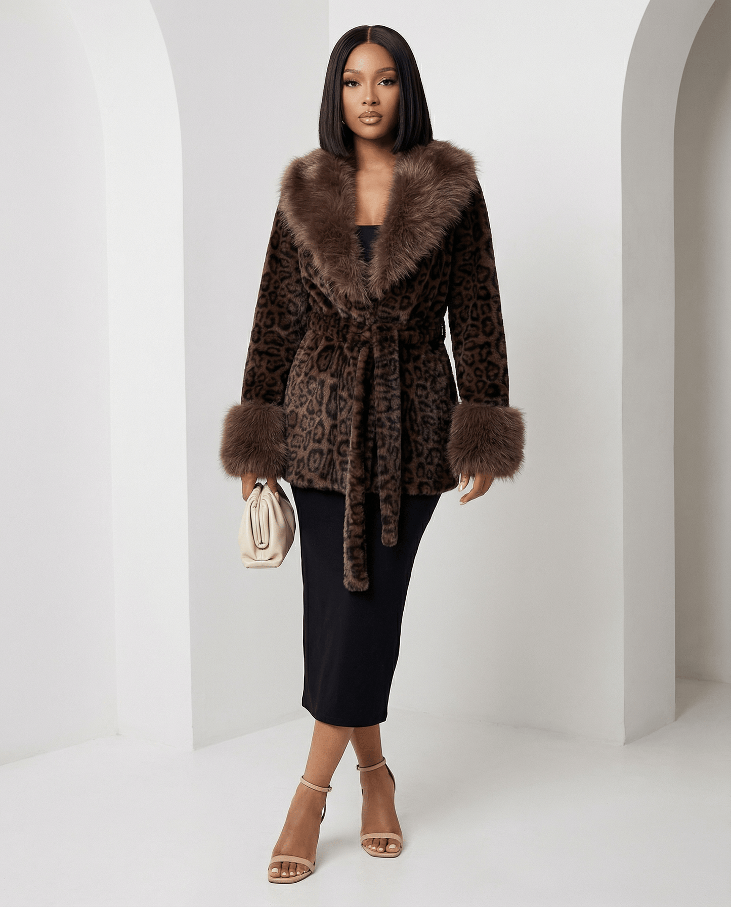 Cocoa leopard faux-fur coat tied at the waist over a black midi skirt, angled pose, full length