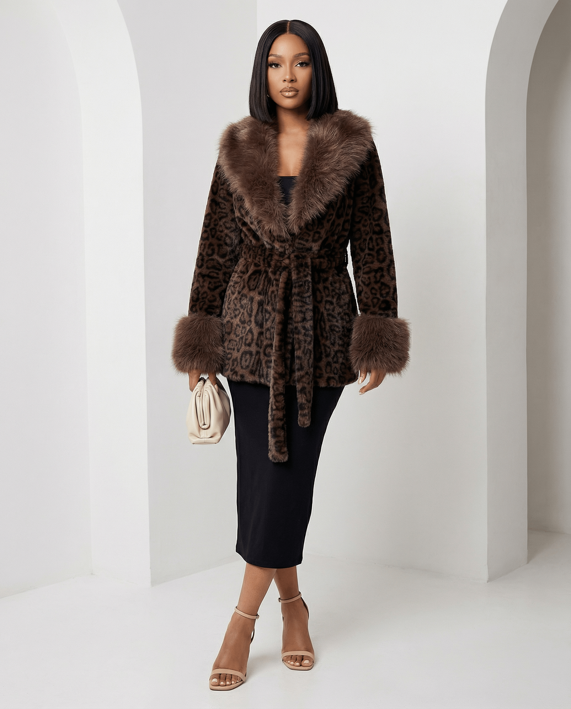 Cocoa leopard faux-fur coat tied at the waist over a black midi skirt, angled pose, full length