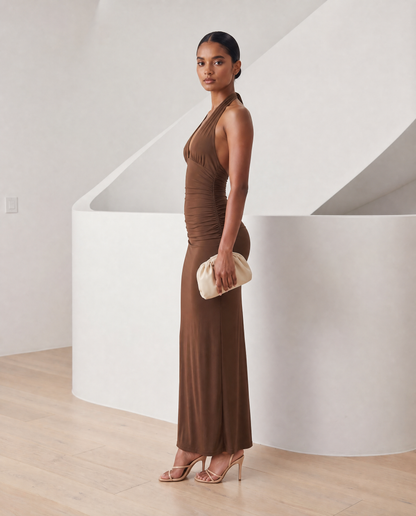 Meridiane halter maxi in deep cocoa brown, side profile with the skirt falling straight to the floor