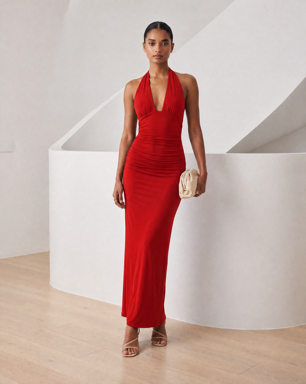 Red Meridiane halter maxi dress worn front on with strappy heels and a cream clutch