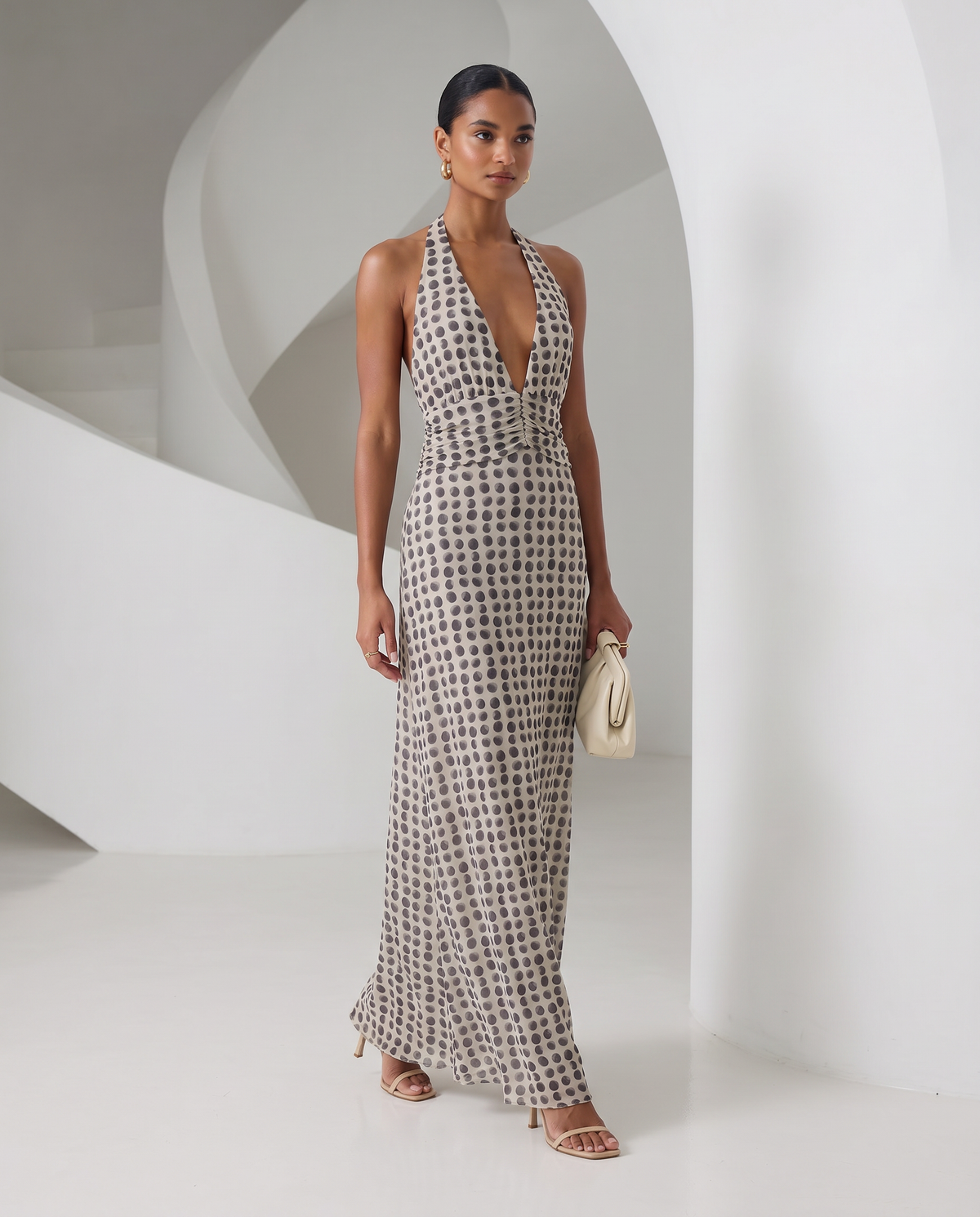 Ivory Mira sundress with brown polka-dot print and a plunging halter neck, full-length front view