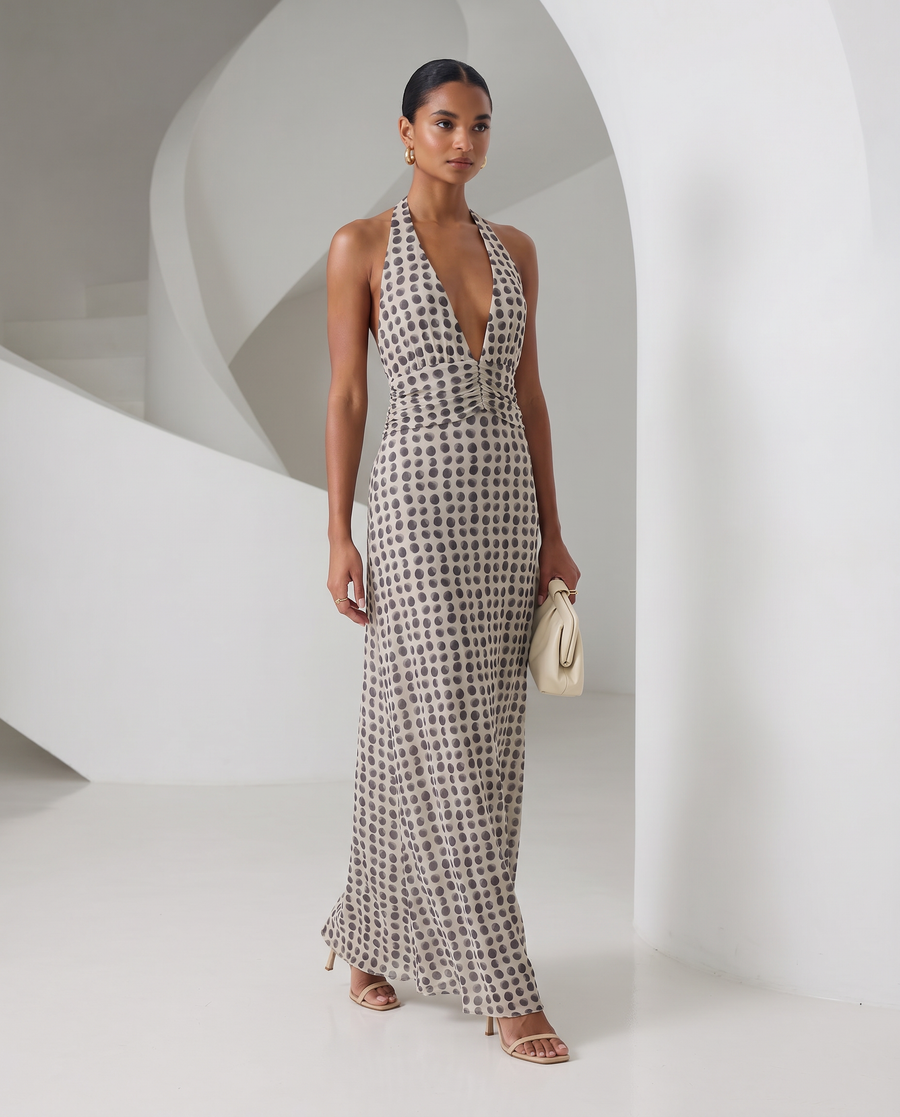 Ivory Mira sundress with brown polka-dot print and a plunging halter neck, full-length front view