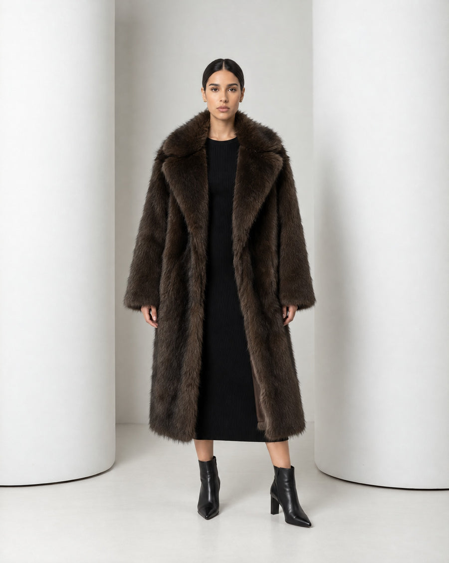 Mirella longline faux-fur coat in bitter chocolate worn open over a black knit midi dress, full length