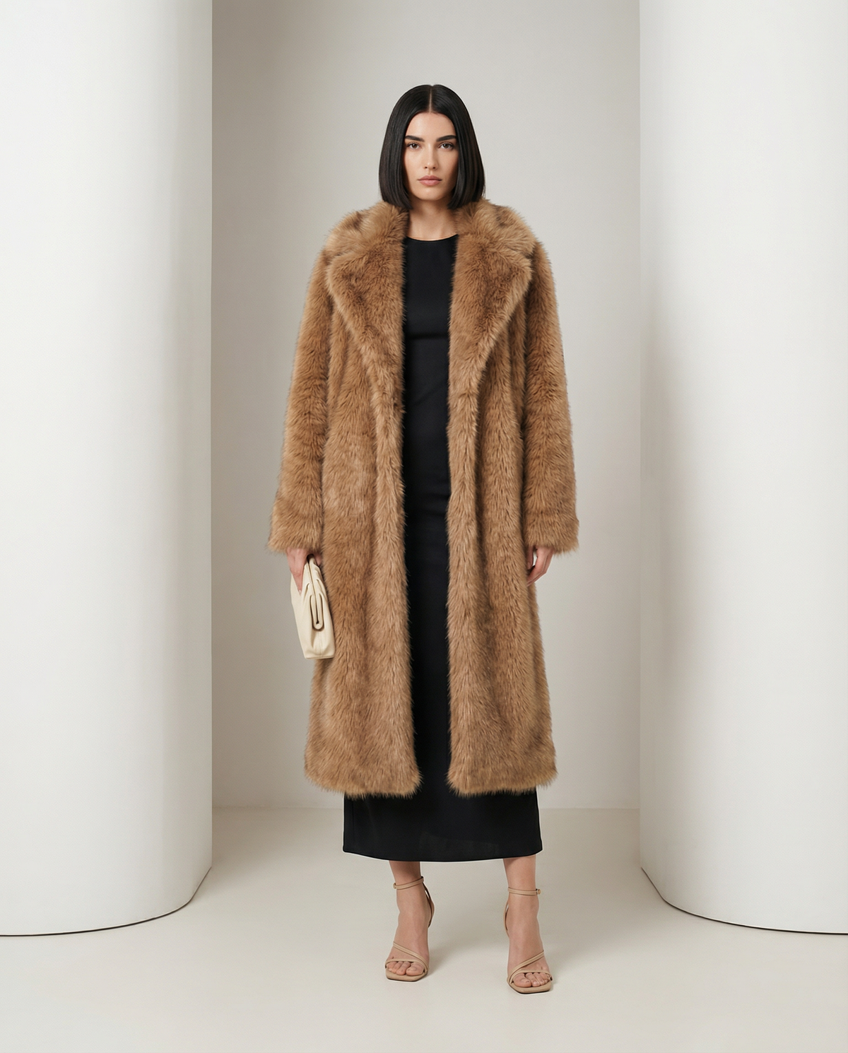 Amber fox Mirella longline faux-fur coat worn open over a black dress, full length front view