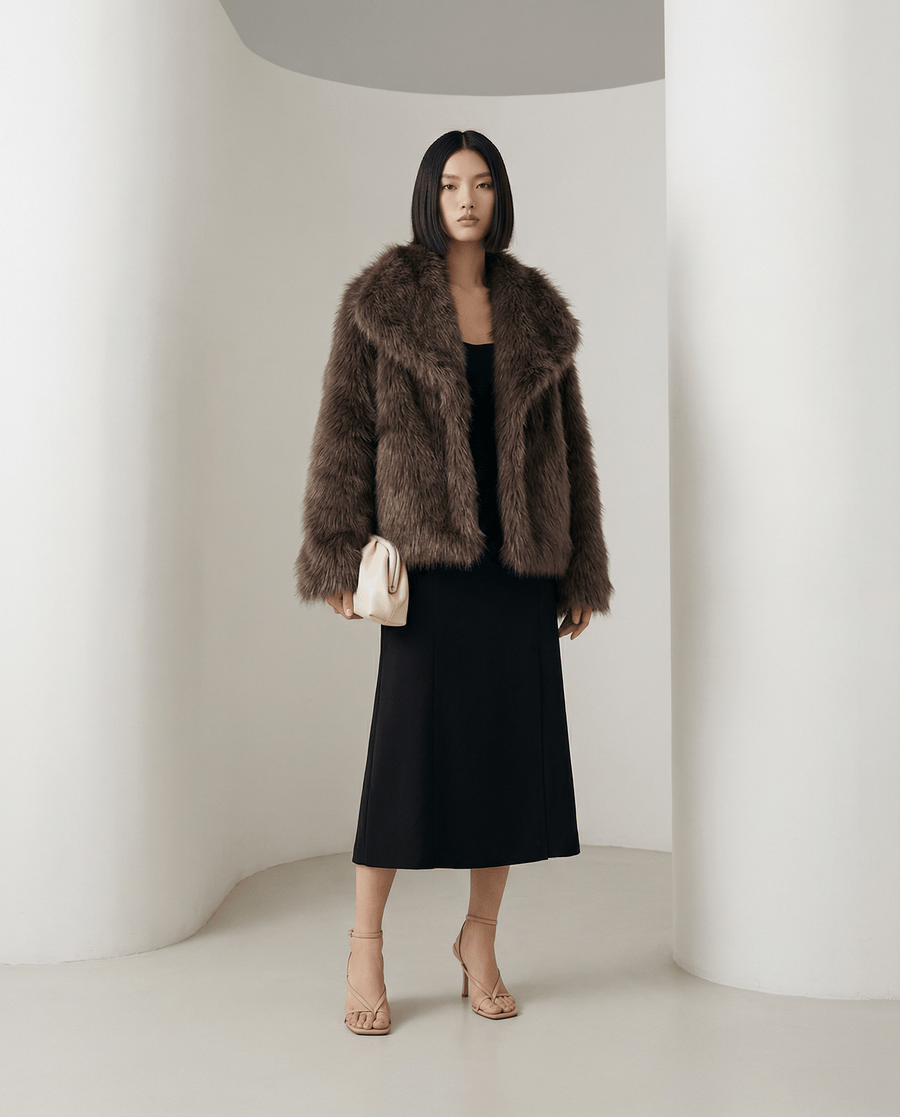 Chocolate brown Neriah plush faux-fur jacket worn open over a black slip midi dress, full length