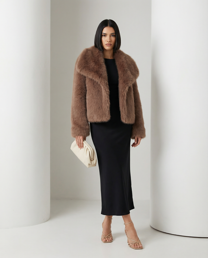 Solid cocoa brown Neriah plush faux-fur jacket worn open over a black bias-cut midi dress